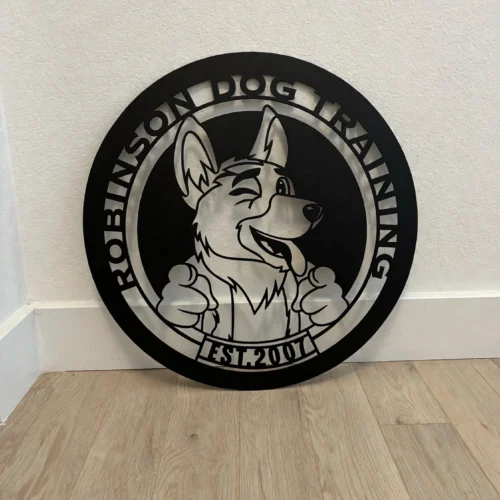 Robinson Dog Training business logo sign, leaning against a wall on a light oak floor